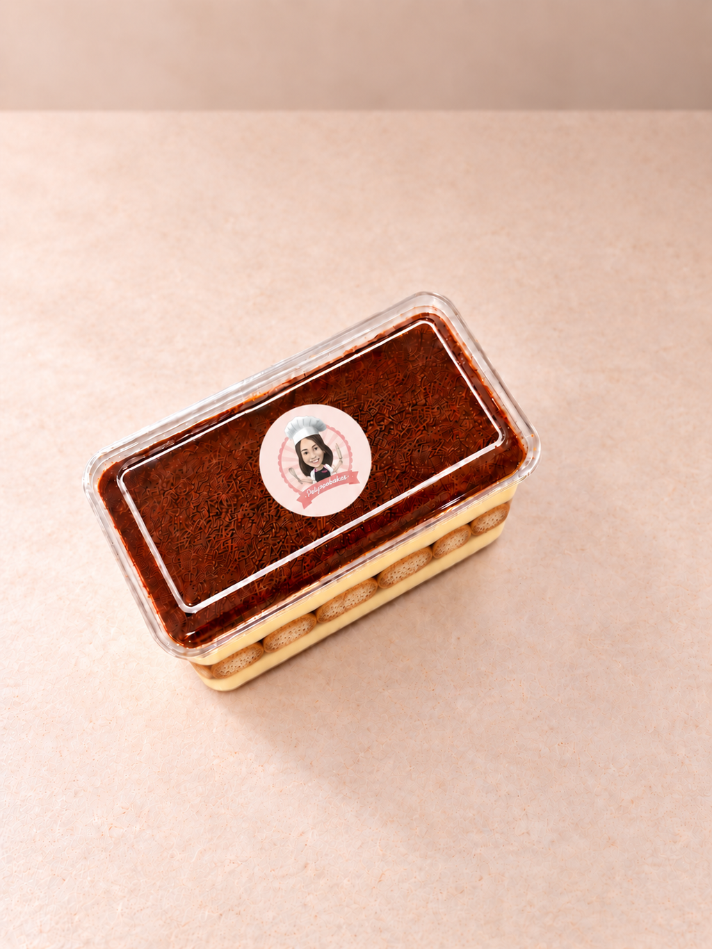 Pelynoobakes tiramisu rectangular tub with branded lid sticker, top view